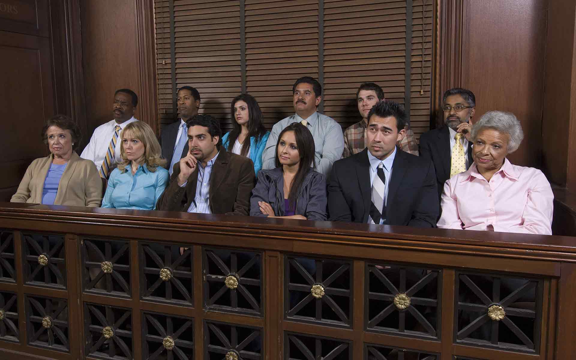 jurors listening to the unfolding case in traditional courtroom setting