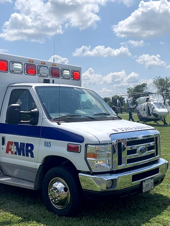 abbott ems parked infront of a medical helicopter on a sunny day