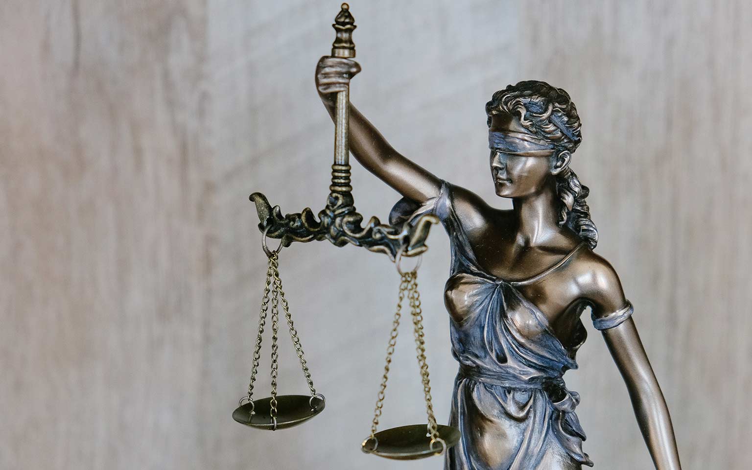 a small statue of lady justice holding the scales of justice